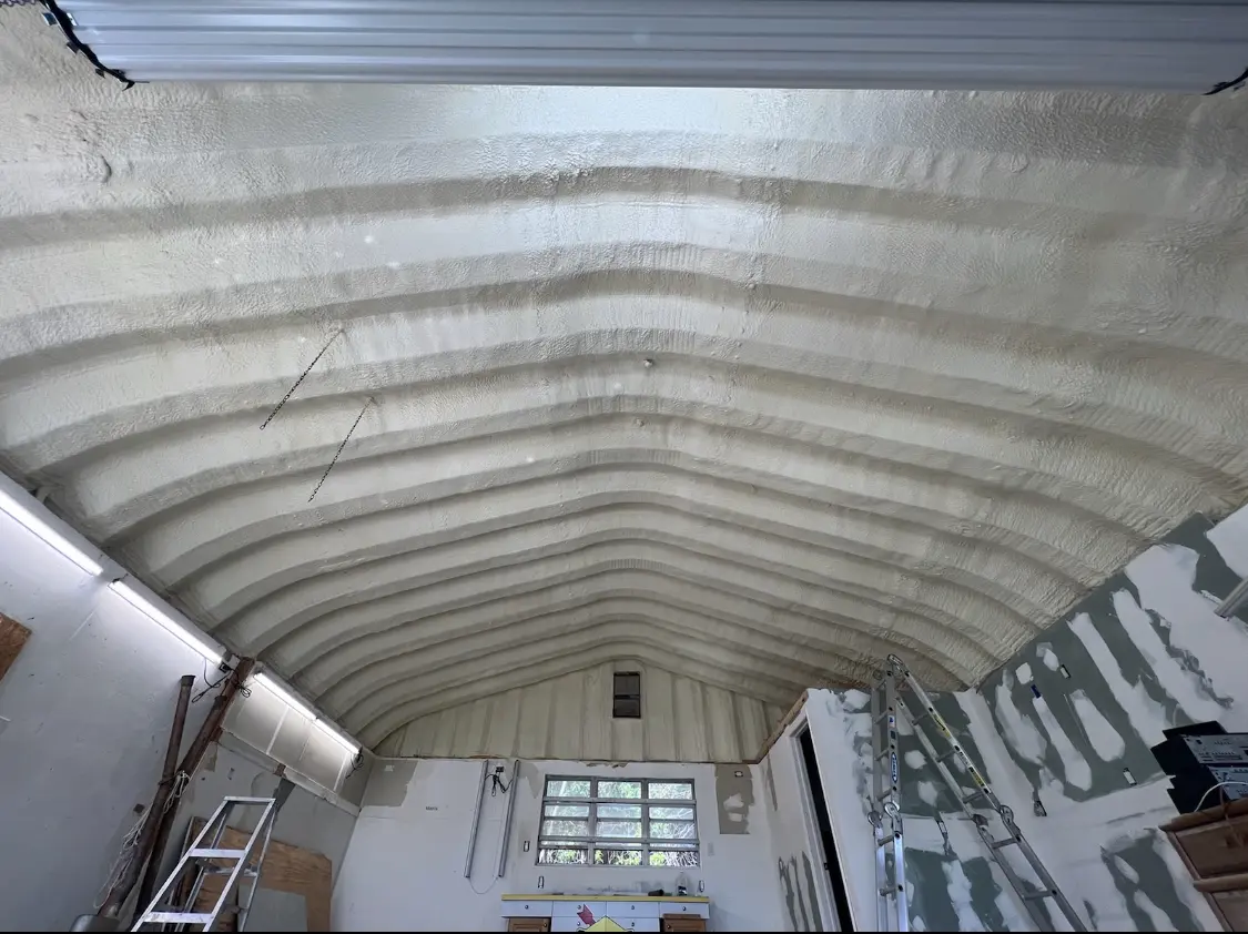 Spray polyurethane foam applied to the underside of a metal roof deck in Falls Church